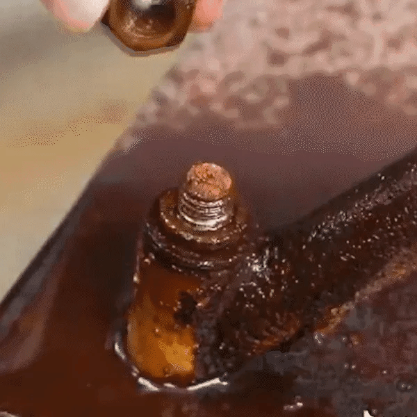 Rust remover liquid applied to a rusted bolt